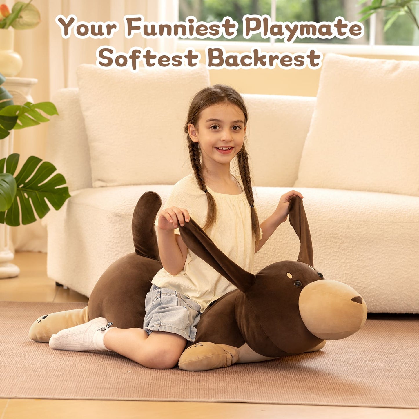 Child sitting on a large brown plush toy resembling a dog in a living room.